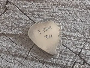 Brass guitar pick with a distressed finish