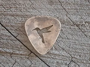 Bronze guitar pick with distressed finish